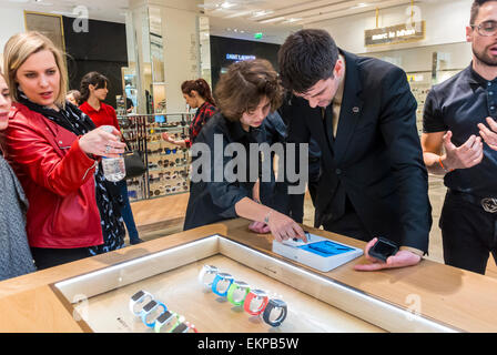 Paris, France. Saleswoman talking to clients in New Apple Corp. Store Opens in French Department Store, Galeries Lafayette for I-Watch products, apple customer Stock Photo