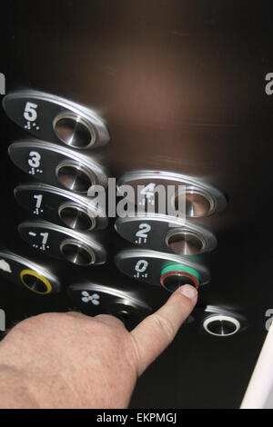 hand operating buttons in an elevator Stock Photo