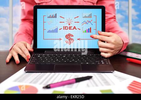 businesswoman pointing to laptop with idea scheme Stock Photo