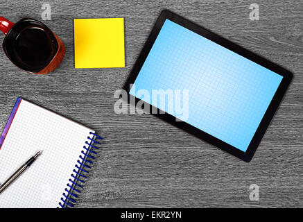 blank tablet and cup of coffee on wooden table Stock Photo