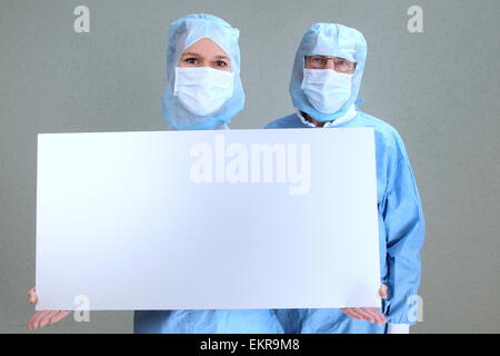 Two doctors in a OP holding an empty board Stock Photo