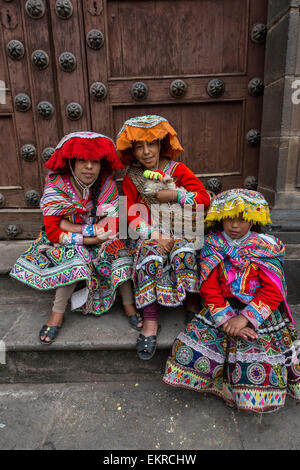 Peru, Cusco.  Young Quechua Women.  They wear traditional dress hoping to be photographed for tips. Stock Photo