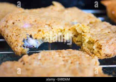 Home baked easter cookies with mini eggs inside on a cooking rack. Stock Photo