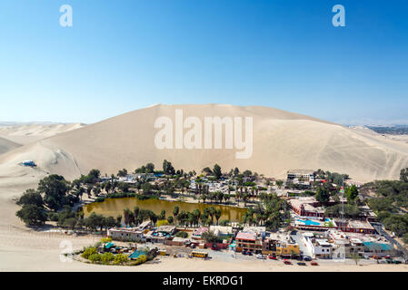 Desert oasis of Huacachina with a sand dune rising above it near Ica, Peru Stock Photo