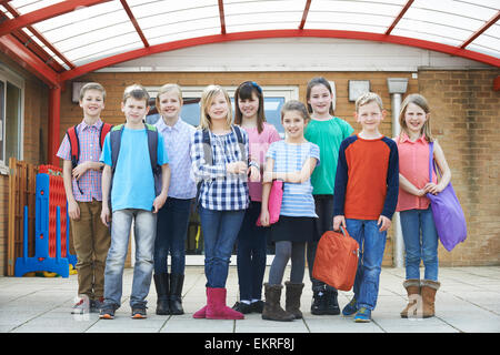 Portrait Of School Pupils Outside Classroom Carrying Bags Stock Photo