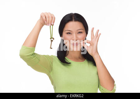 Woman locked mouth with key on white Stock Photo