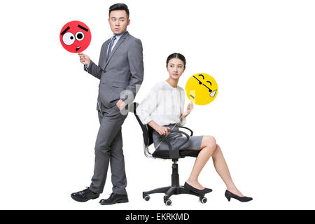 Business person holding embarrassed emoticon faces Stock Photo