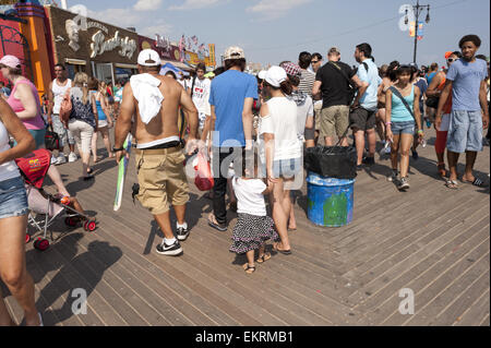 Crowds line the boardwalk at Coney Island in Brooklyn, NY on the 4th of July, 2012 during  the second heat wave of the season. Stock Photo