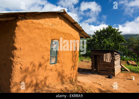 Malawi is one of the poorest countries in the world, many people still live in traditional mud hut houses, this one is on the Zomba plateau. Stock Photo