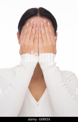 Woman closed face with hands Stock Photo