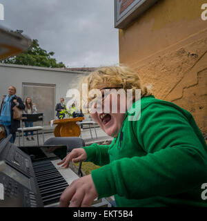 Boy playing piano and singing. Annual end of summer festival-Cultural Festival (Menningarnott),  Reykjavik, Iceland Stock Photo