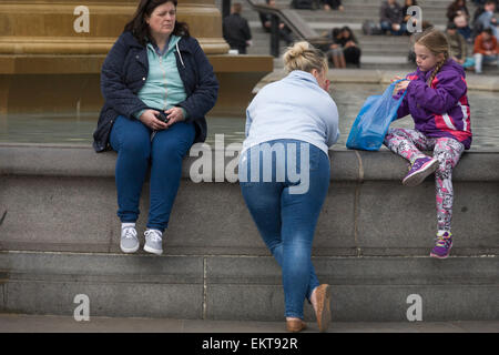 People visiting the sights in the capital gather in Trafalgar Square on 13th April 2015 in London, United Kingdom. This is one of the major tourist sites in London where people come to enjoy the open space and fountains.