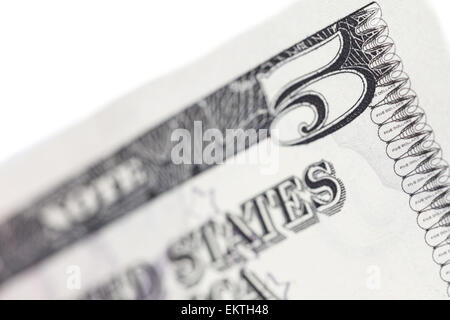 Part of five dollar bill macro on white background, shallow depth of field Stock Photo