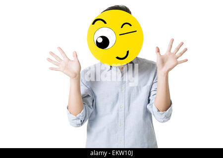 Young man with a winking emoticon face in front of his face Stock Photo ...