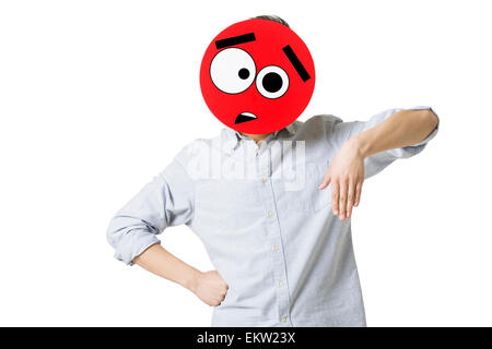 Young man with a confused emoticon face in front of his face Stock Photo