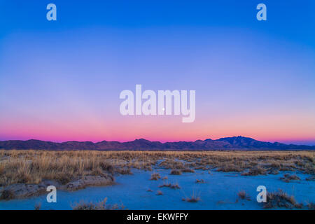 December 15, 2013 - Sunset twilight colors and the waxing gibbous moon over the Chiricahua Mountains in southeast Arizona, south Stock Photo