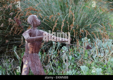 Metal sculpture of a hunter holding a bow and arrow in Harold Porter National Botanical Gardens, Betty's Bay, Stock Photo