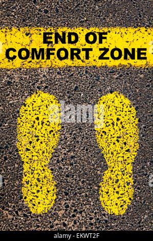 End of Comfort Zone message. Conceptual image with yellow paint footsteps on the road in front of horizontal line over asphalt stone background. Stock Photo