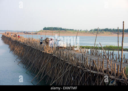 People are crossing a bamboo bridge that stretches over the Mekong river in Kampong Cham, Cambodia. Stock Photo
