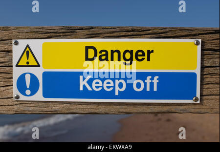 Danger keep off sign on a groyn at a beach in Dawlish Warren Devon England UK Stock Photo