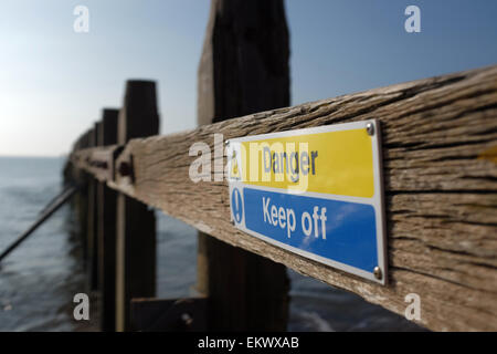 Danger keep off sign on a groyn at a beach in Dawlish Warren Devon England UK Stock Photo