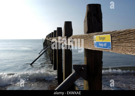 Danger keep off sign on a groyn at a beach in Dawlish Warren Devon England UK Stock Photo