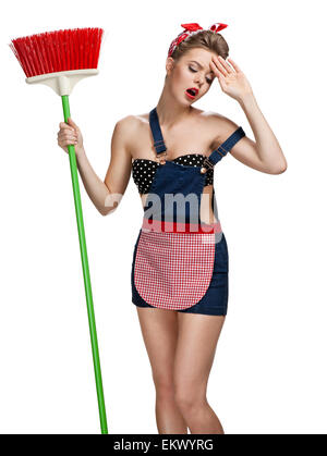 Cleaning lady standing unhappy after spring cleaning with broom Stock Photo
