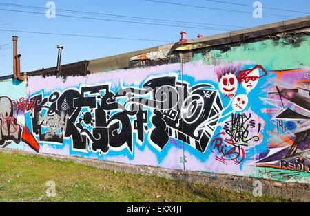 Saint-Petersburg, Russia - April 6, 2015: Graffiti with chaotic patterns and text  on old gray concrete garage walls Stock Photo