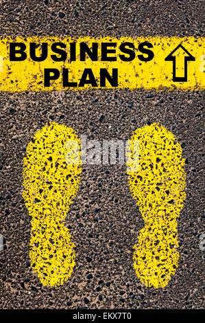 Business Plan message. Conceptual image with yellow paint footsteps on the road in front of horizontal line over asphalt Stock Photo