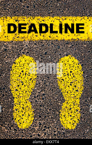 Deadline message. Conceptual image with yellow paint footsteps on the road in front of horizontal line over asphalt Stock Photo