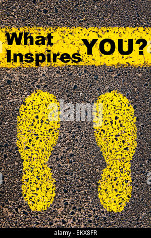 What Inspires You? Conceptual image with yellow paint footsteps on the road in front of horizontal line over asphalt Stock Photo