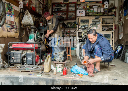 Two nepali mechanics in a workshop in Kathmandu, Nepal Stock Photo