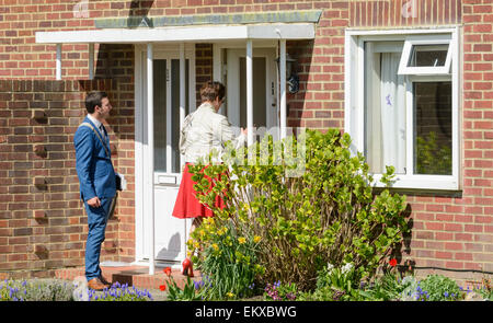 A pair of Jehovah's Witnesses knocking on doors in England, UK. Stock Photo