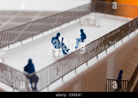 Miniature human figures in architectural model Stock Photo