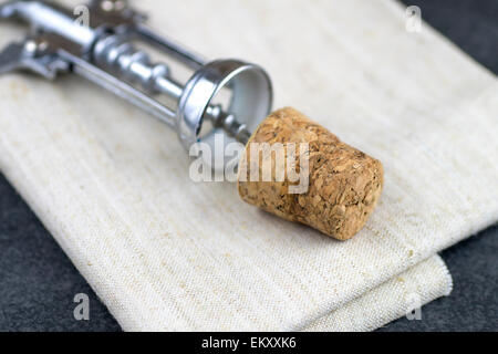 Wine cork and corkscrew on  table, close up Stock Photo