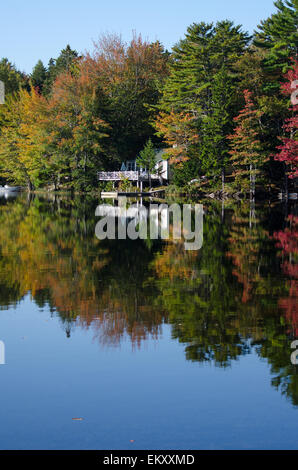 Fall foliage reflected in the still waters of Long Pond on Mount Desert Island, Maine. Stock Photo