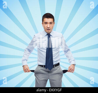 surprised businessman showing empty pockets Stock Photo