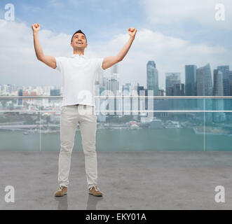 happy man with raised hands Stock Photo