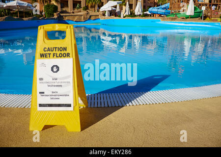 Caution Wet Floor Sign With A Note To Say The Pool Is Closed Coral Sea Aqua Club Resort El-Salam Road Sharm El Sheikh Egypt Stock Photo