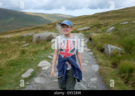 A boy treks up Mount Snowdon Snowdonia Stock Photo