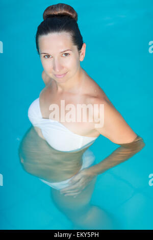 Beautiful pregnant woman in swimming pool Stock Photo