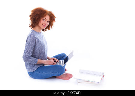 Black African American student girl using a laptop, over white background Stock Photo