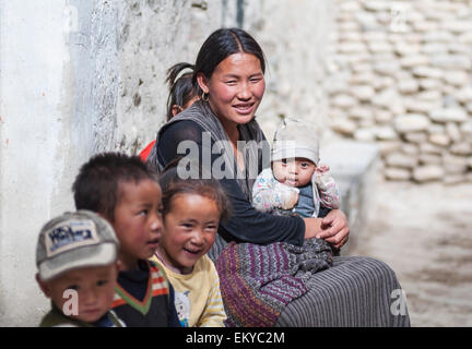 Nepal, Mustang Region, Happy family of smiling young Nepalese woman and lot of children around; Lo Manthang Stock Photo