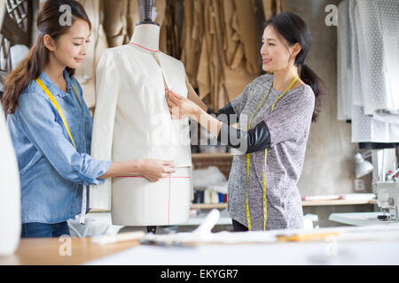 Two female fashion designers working in studio Stock Photo