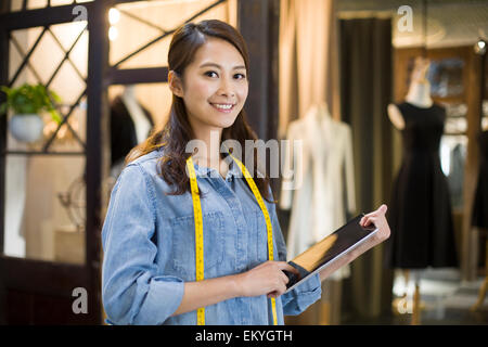 Female fashion designer using digital tablet Stock Photo