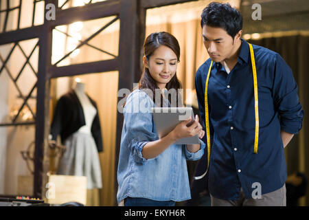 Fashion designers using digital tablet Stock Photo