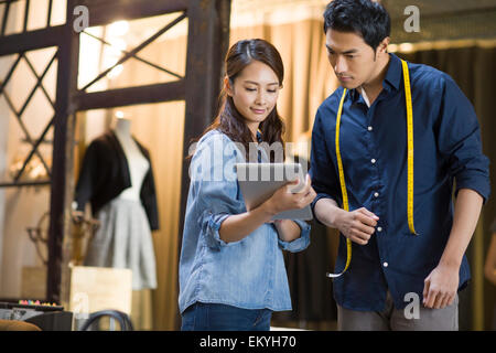 Fashion designers using digital tablet Stock Photo