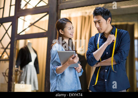 Fashion designers using digital tablet Stock Photo