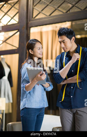 Fashion designers using digital tablet Stock Photo