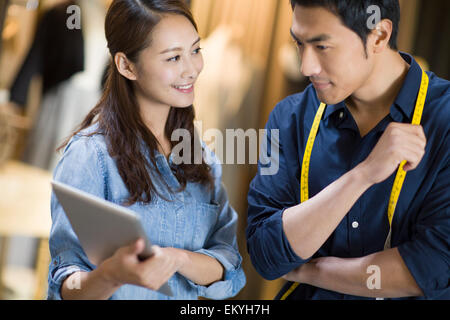 Fashion designers using digital tablet Stock Photo